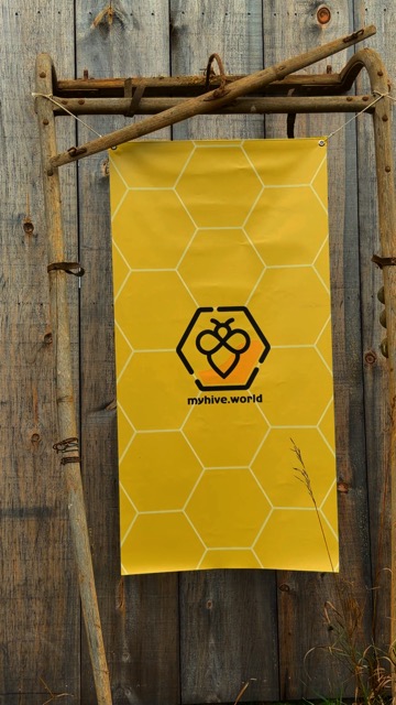 The MyHive banner hanging from branches against a barn wall
